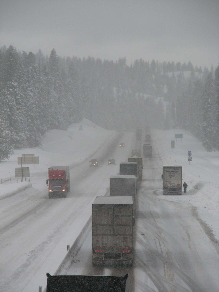 Winter driving over a snowy mountain pass.